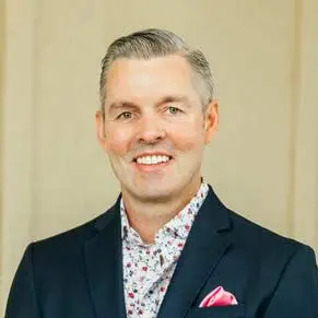 headshot of man in stylish suit with pocket square