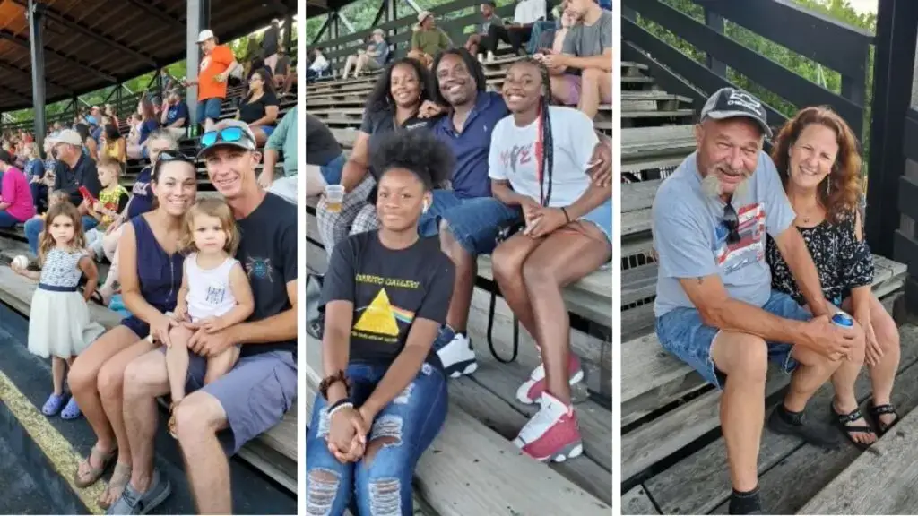 Newport News office staff sitting on bleachers during Peninsula Pilots baseball game